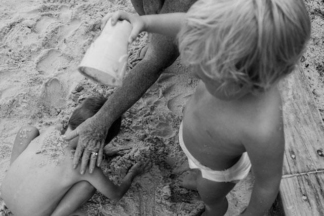 toddler-pouring-a-cup-of-sand-over-his-cousin-Day-in-the-Life-Photography-Storytelling-Gold-Coast-Australia