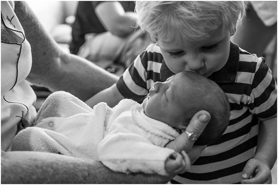 Big-brother-kissing-new-baby-sister-gold-coast-First-Glimpse-newborn-photography