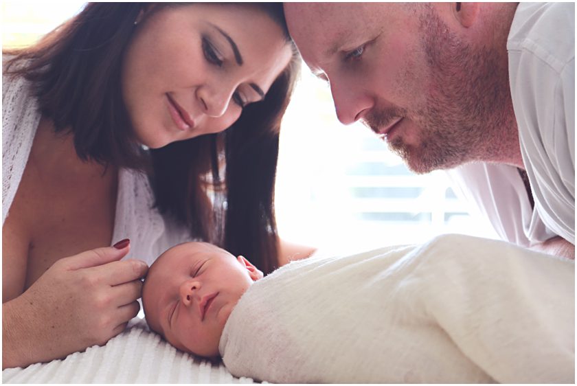 In-home-newborn-photography-parents-loving-over-their-new-son-gold-coast