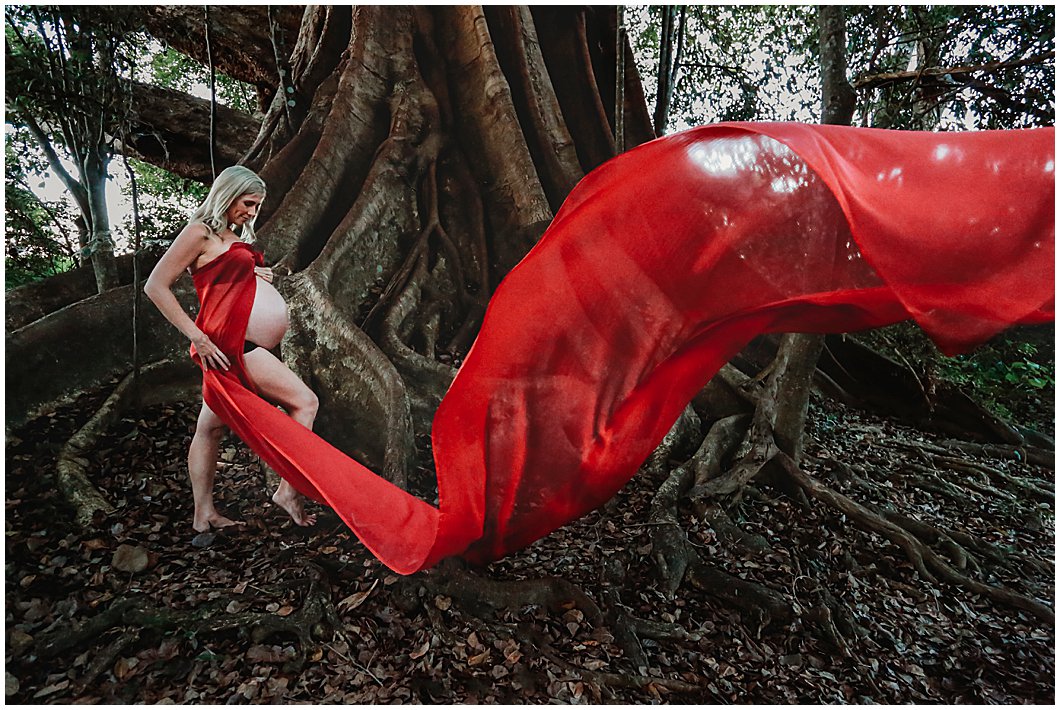 Rainforest-inspired-maternity-photography-with-striking-red-flowing-material-gold-coase-maternity-photography