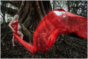 Rainforest-inspired-maternity-photography-with-striking-red-flowing-material-gold-coase-maternity-photography