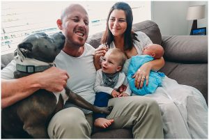 New-baby-with-family-and-dog-licking-dad-with-toddlers-laughing-gold-coast-inhome-newborn-photography