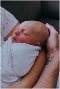 new-baby-in-hands-of-both-parents-inhome-newborn-photography-gold-coast