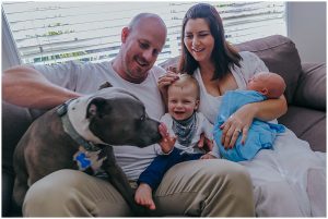 energetic-dog-joins-family-on-the-couch-for-inhome-newborn-photography-session-gold-coast-and-brisbane