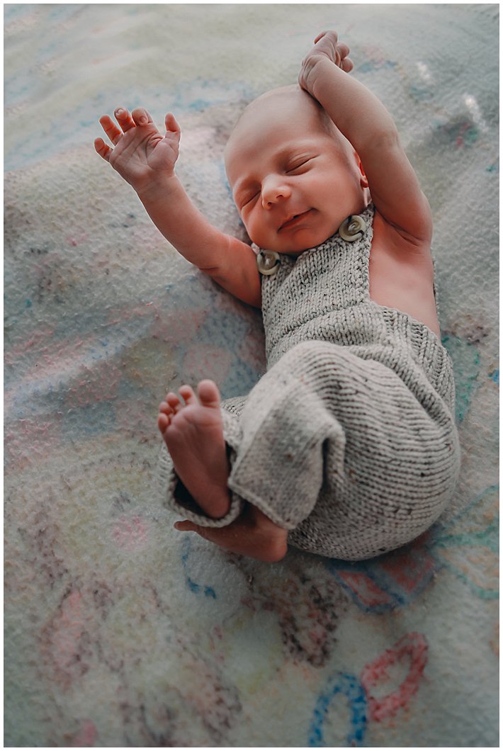 newborn-baby-reaching-up-with-hands-and-feet-at-newborn-inhome-lifestyle-photography-session-gold-coast