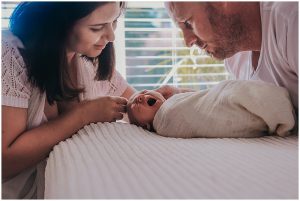 parents-looking-over-newborn-son-as-he-yawns-gold-coast-newborn-photography