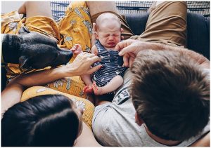gold-coast-newborn-in-home-lifestyle-photography-dog-mum-and-dad-looking-at-newborn-baby-during-inhome-newborn-photography-session