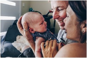 mum-and-dad-talk-with-newborn-son-at-gold-coast-newborn-family-documentary-photography-session