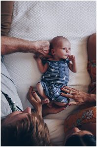 Beautiful-scene-of-newborn-laying-on-bed-being-looked-on-and-loved-by-mum-and-dad-gold-coast