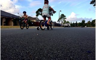 two-boys-on-bike-and-scooter-riding-out-the-front-of-their-house-gold-coast-short-story-telling-photography