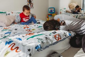 Family-documentary-mother-playing-with-son-on-the-bed