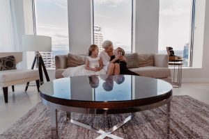 Preparing-to-walk-down-the-aisle-on-her-wedding-day-this-stunning-bride-is-given-last-minute-kisses-and-cuddles-from-her-beautiful-children-gold-coast-family-documentary-wedding-photography