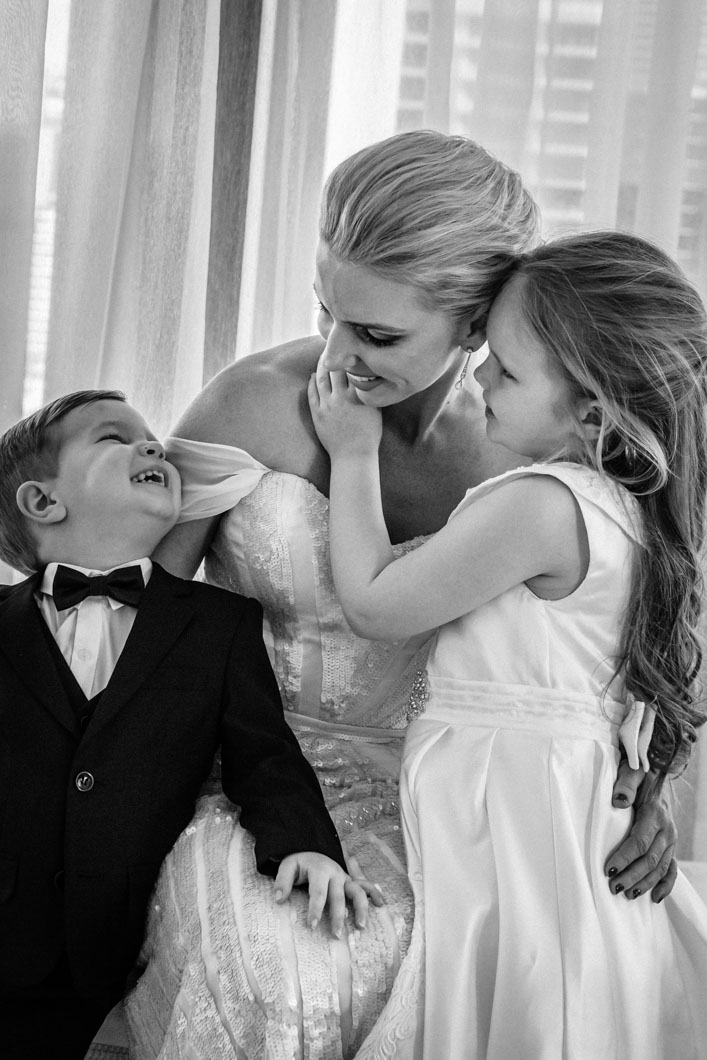 Chidren-cuddling-their-beautiful-bride-mother-before-walking-down-the-aisle-gold-coast-family-documentary-wedding-photography