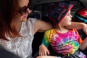 young-boy-showing-mum-the-sights-together-in-the-backseat-of-the-car