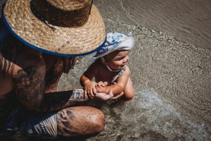 Beautiful-baby-boy-crawling-into-the-waves-and-exploring-the-beach
