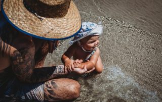 Beautiful-baby-boy-crawling-into-the-waves-and-exploring-the-beach