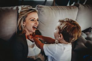 blog-image-young-boy-plaing-on-couch-with-mum-tickling
