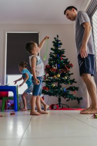 young-boy-showing-dad-slinky-as-they-put-up-the-xmas-tree