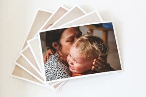 styled printed photographs featuring a mum hugging and comforting her upset toddler