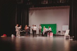 View of front stage during a technical rehearsal of Live at Five Thearte production on the Gold Coast with actor gathered on set preparing for run through of play
