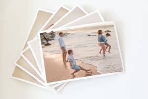 picture-of-fine-art-prints-spread-across-table-showing-boy-falling-against-a-wave