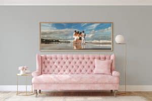 Room-view-of-pink-couch-with-impact-size-wood-framed-canvas-of-family-at-the-beach